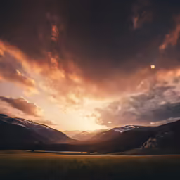 the sun is setting over the mountains and valleys