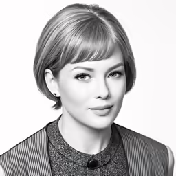 woman with a hair cut is posing for a photograph