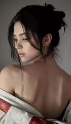 a woman with tattoos on her back in bed