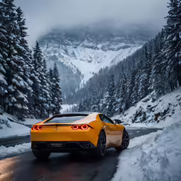 a sports car driving down the road in front of snowy mountains