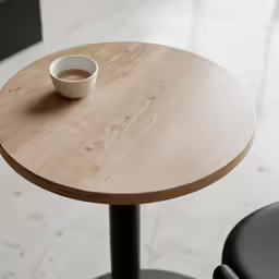a close - up photo of a table with a cup of coffee on top of it