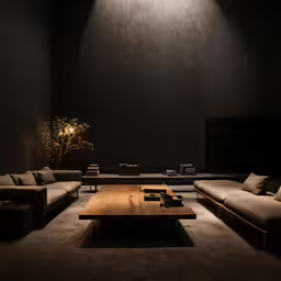 a couch sitting inside of a dark living room
