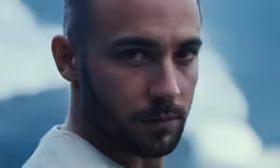 a young man with a beard and short hair