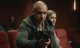 a man taking pictures of himself while his friend takes the picture