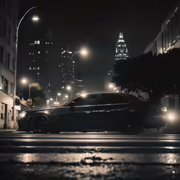 a black car driving down a street at night