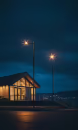 the exterior of a restaurant with two large lights