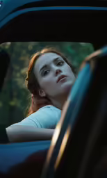 a girl looking out of a car window