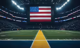 the american flag is displayed in the middle of a football field