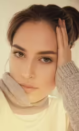 a woman holding her hands to the ears