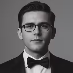 black and white photograph of a young man wearing a suit and bow tie