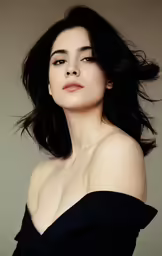a beautiful woman in black dress posing for a picture