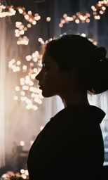 a woman stands in front of light reflecting off the glass