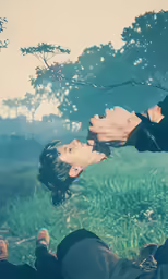 a person is laying in the grass in a field
