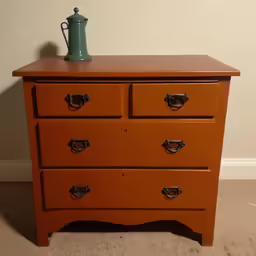 a small wooden dresser sitting in the corner of a room
