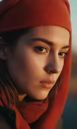 a girl in red wears her hood pulled over