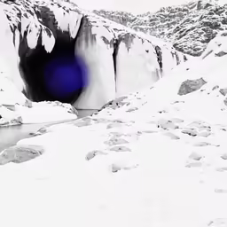 a dark hole on the ground with snow around it