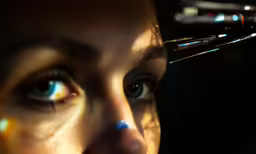 a woman with blue eyes and some metallic equipment