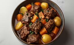 an oxee and meat soup is displayed in a bowl