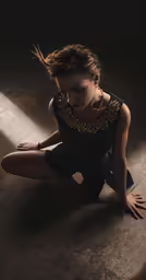 a woman that is sitting on the ground