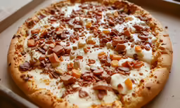 an uncooked pizza with cheese and nuts in it