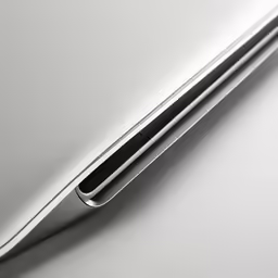 silver surface, silver laptop with black pen in the back