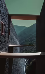 an empty room with a mountain scene and a window overlooking the mountains