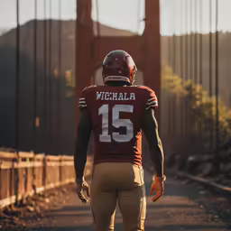 a football player walks across the bridge in front of a bridge
