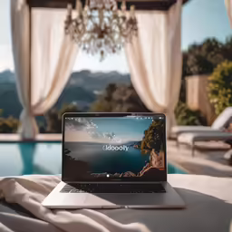 a laptop is open on a table near the pool