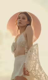 a woman is wearing a bikini and posing outdoors