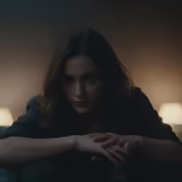 a woman that is sitting down on the couch
