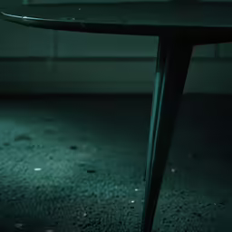 a dark table with a round black top