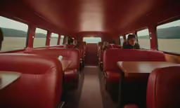 a woman is sitting inside of a bus