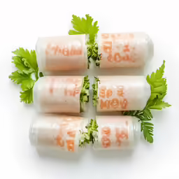 five wrapped sandwiches that have lettuce and sauce in them