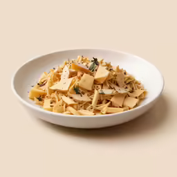 a white bowl filled with pasta and herbs