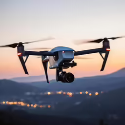 a small, black - and - white quad - rotored camera controlled aerial plane with its landing gear deployed