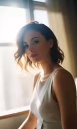 a young woman sitting by a window in a room