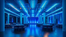 the blue light above the dining area is shining down,an indoor dinner hall is shown with blue lighting