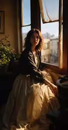 a woman in a white dress sitting on the windowsill