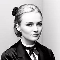 a woman with blonde hair wearing a black suit