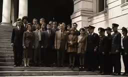 a group of people dressed up and standing on some steps