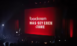 a person is at the top of a large screen