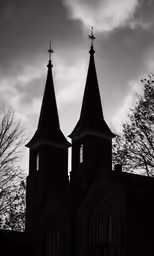 two towers of a church in a cloudy sky