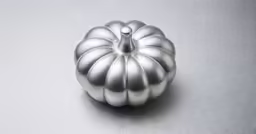 a silver metal object sitting on top of a table