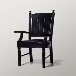 a black chair is sitting in a corner