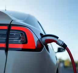 a modern car is getting a service at the gas pump