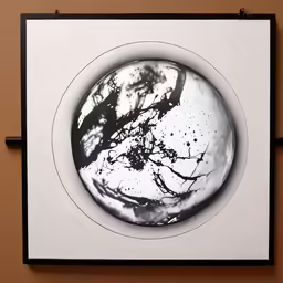 a black and white photograph on top of a square paper