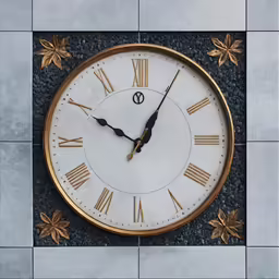 a golden clock on a white and blue wall