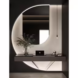 a circular mirror hanging over a bathroom counter