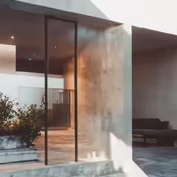 a photo of a cement building taken through glass