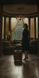 a lady standing in front of the door looking in